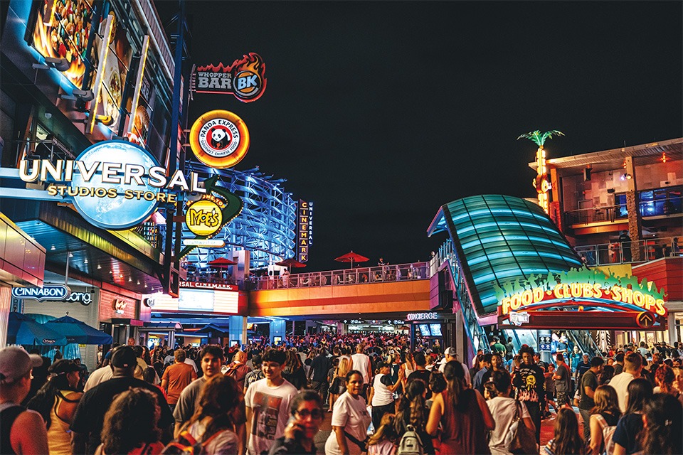 people walking around Universal Orlando Resort at night