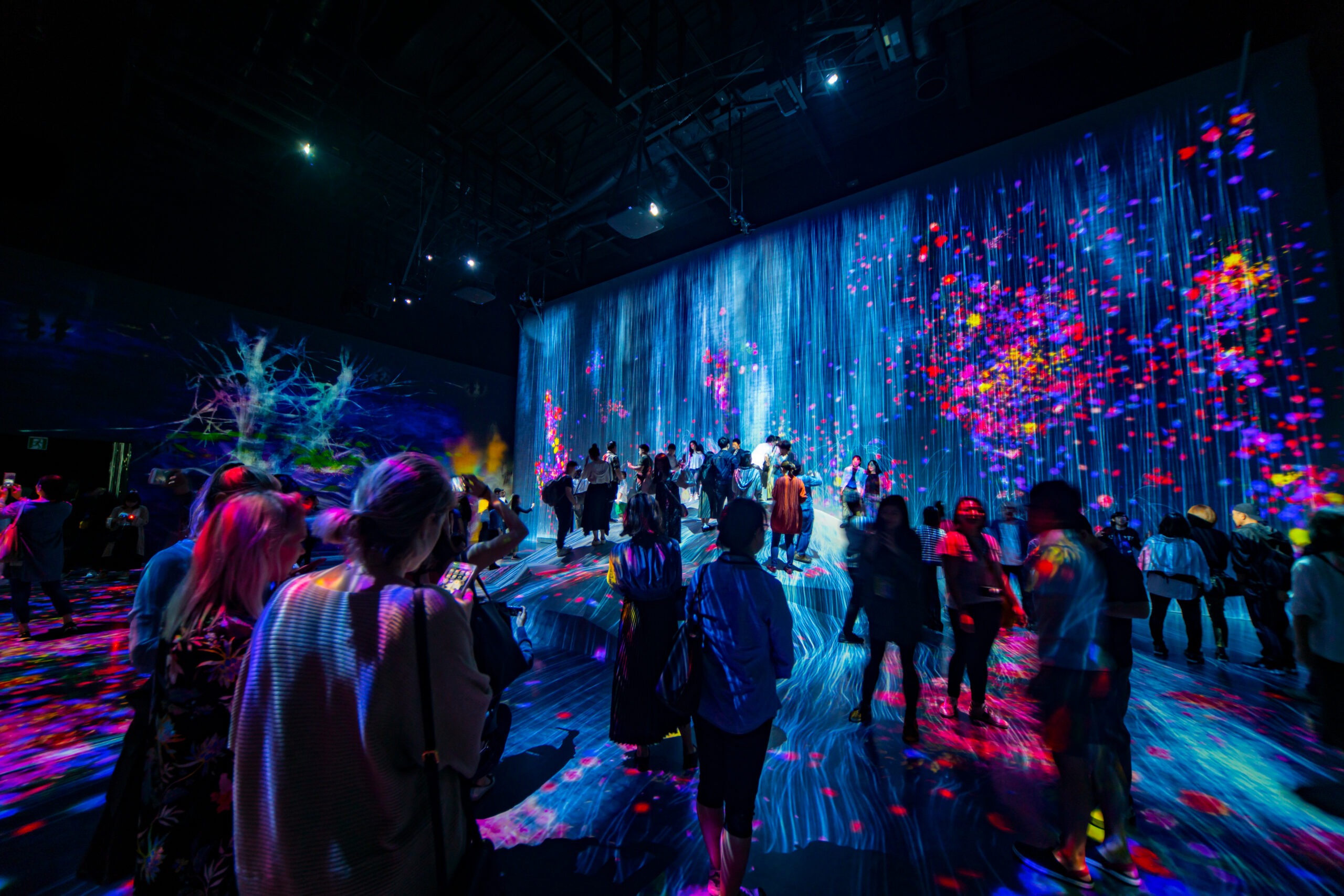 people standing in room with colorful event design