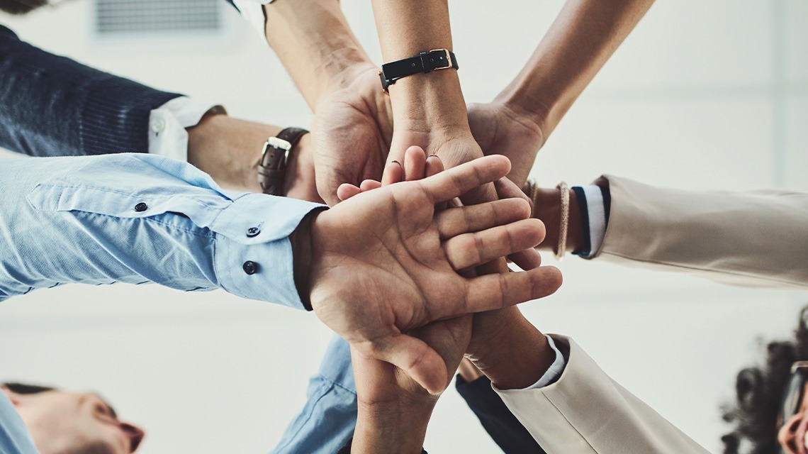 people stacking hands