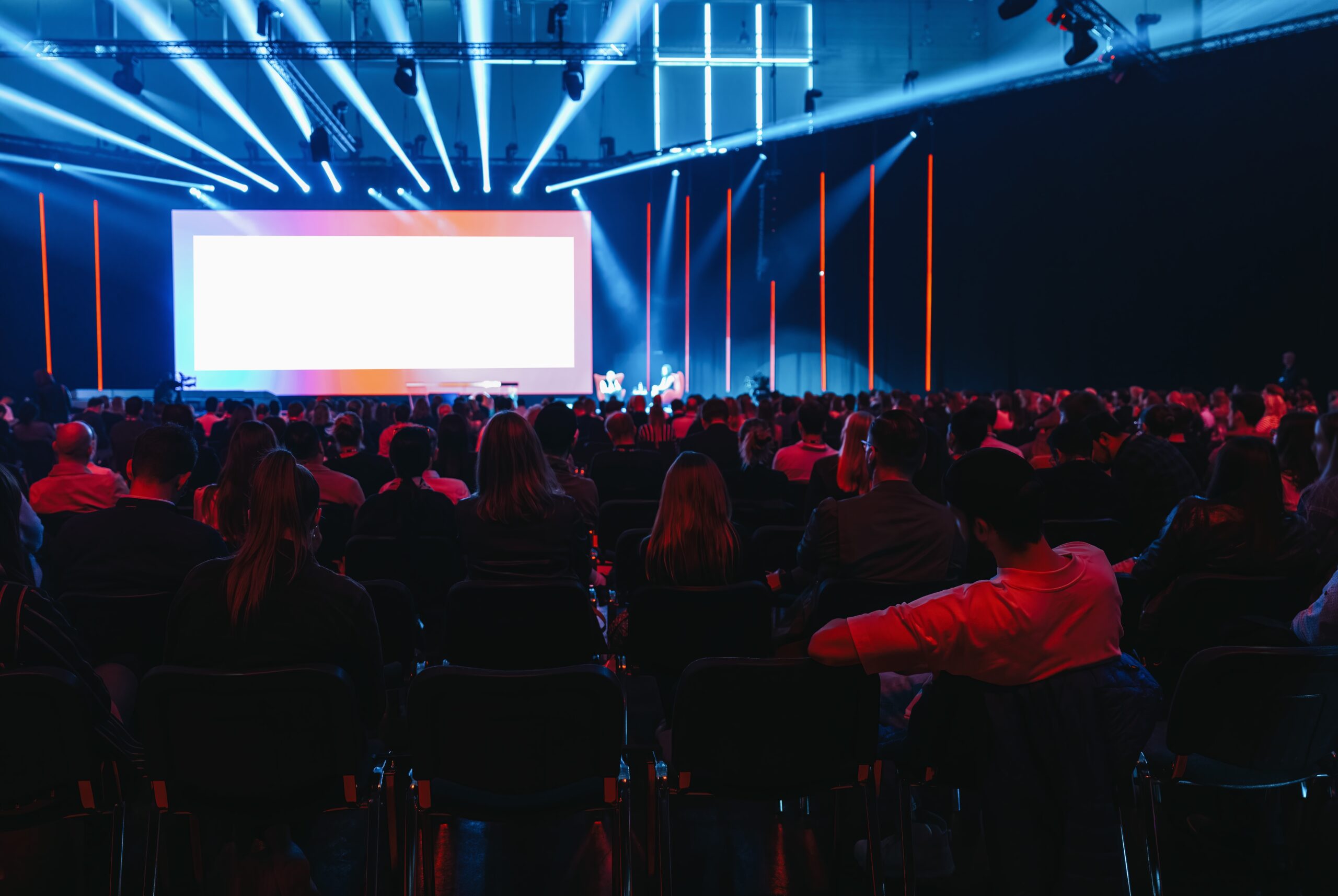 large group of businesspeople in dark room with strobe lights