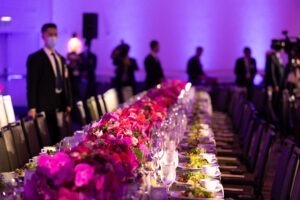 table lined with pink flowers and salad