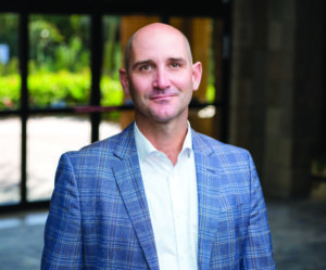 Brad Schumacher wearing light blue sport coat and white button up shirt