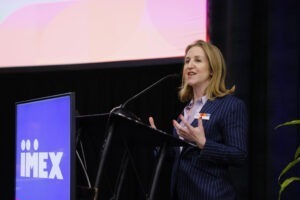 Carina Bauer at microphone at closing IMEX press conference