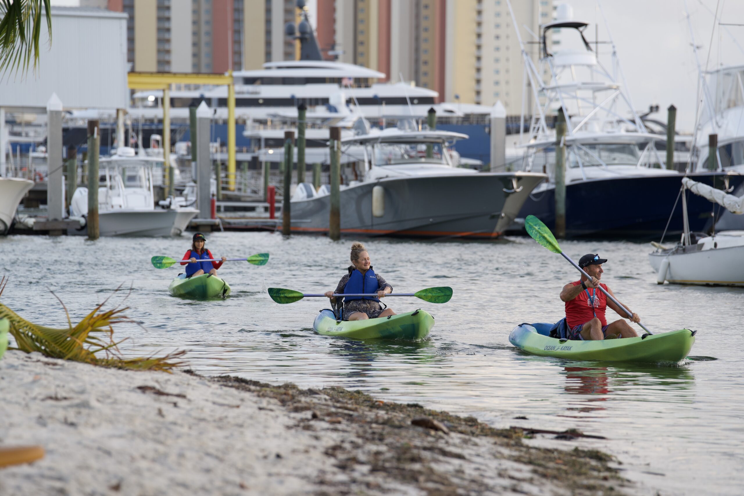 three people kayaking in water