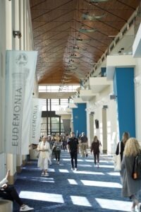 people walking in convention center foyer