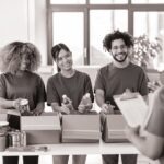 black and white image of four people recycling