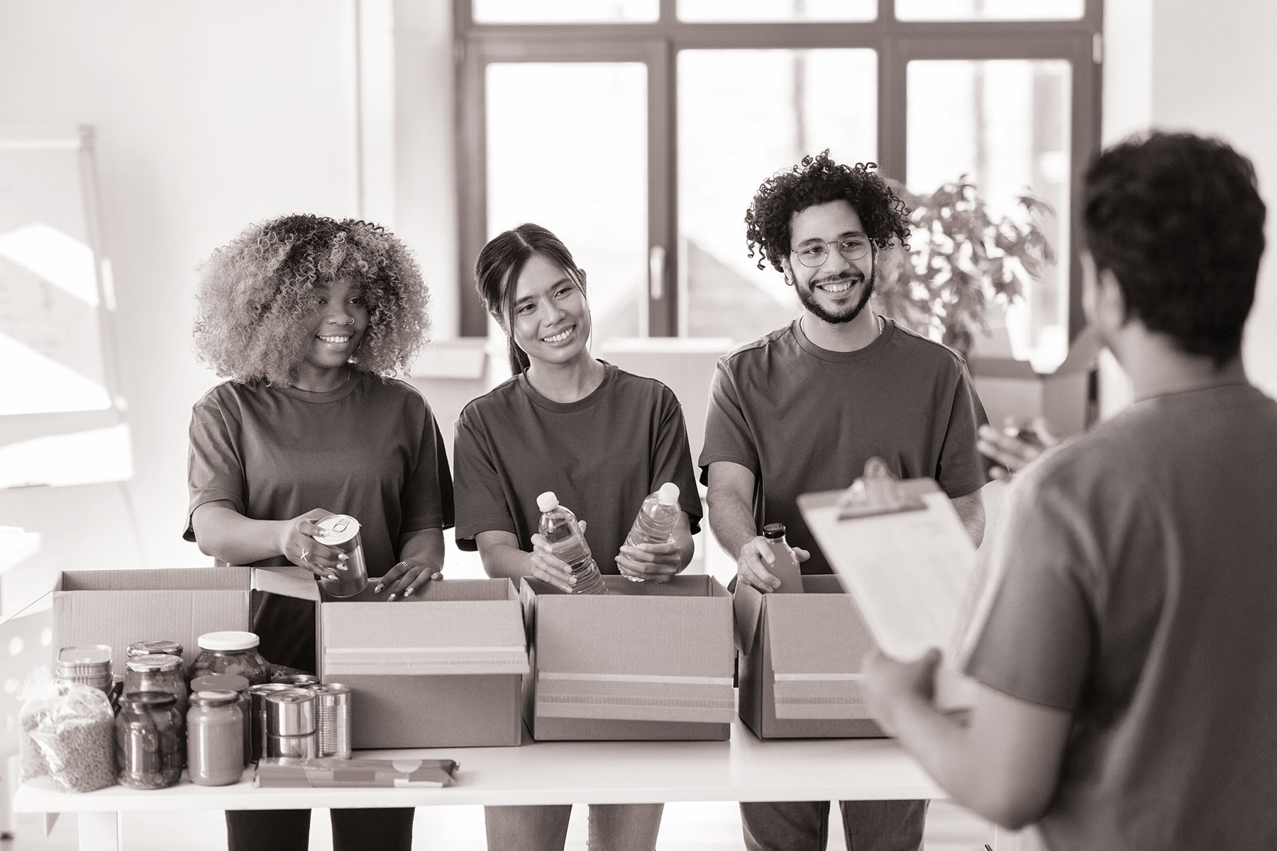 black and white image of four people recycling