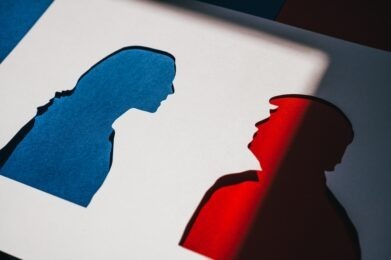 Papercut Silhouettes of Kamala Harris and Donald Trump in Blue and Red