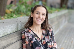 Brittany Glover sitting on park bench, smiling