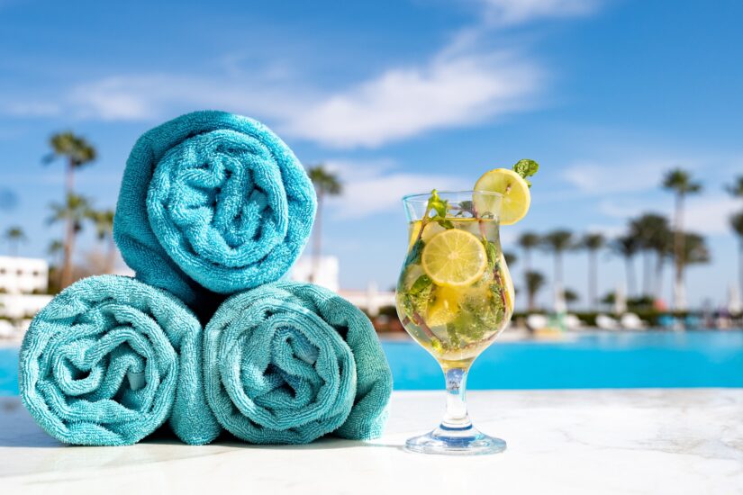 cocktails and towels next to hotel pool