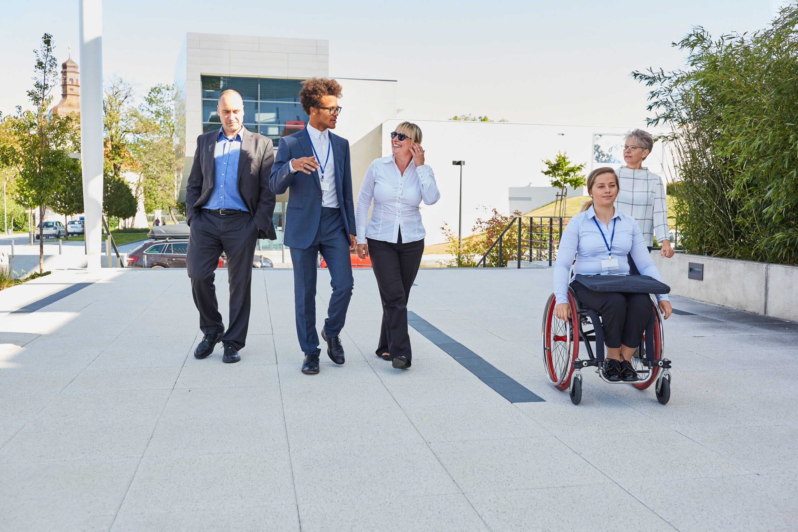 Business people from the multicultural business team with a colleague in a wheelchair