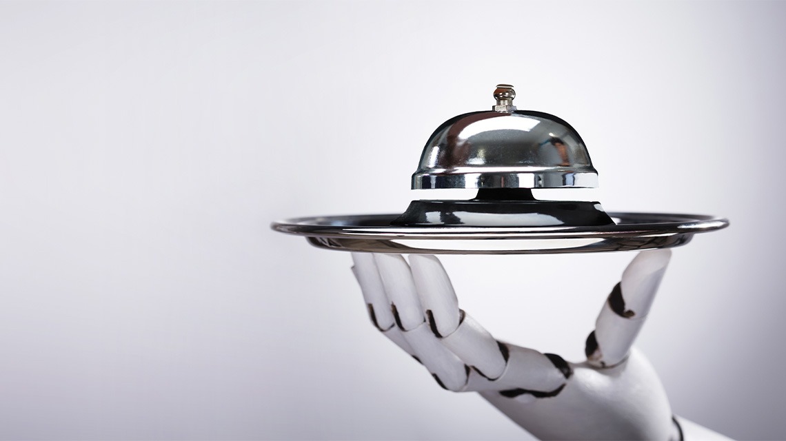 Robot hand holding bell on platter