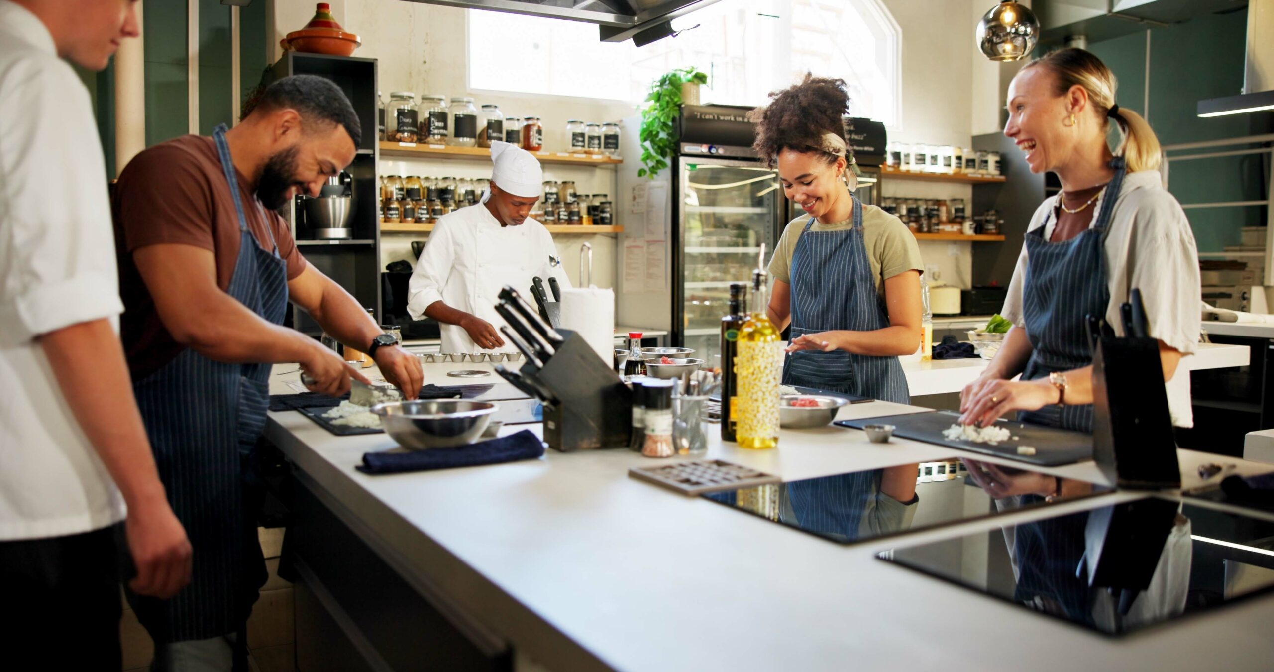 Chef teaching students in kitchen