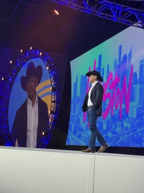 Sherrif Karamat on stage in cowboy hat in Houston