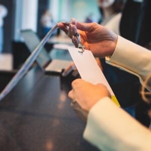 An attendee checks into an event and holds up their name badge, image for Hilton Meetings Maximizer story