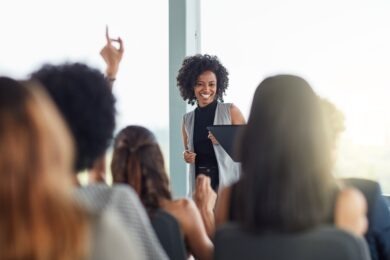 Businesswoman smiling in seminar in front of other women