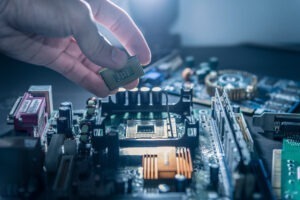 AI environmental impact story image: technician putting cpu microprocessor on motherboard socket