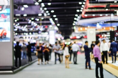 Abstract blurred background image with light of crowd people at cars exhibition show