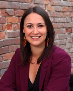 Brooke Eder wearing purple coat and black shirt