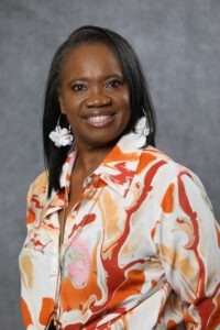 Hortensia Simmons wearing orange and white shirt long sleeve shirt