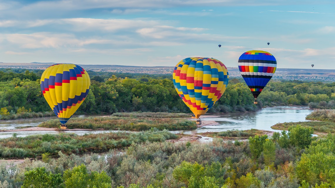 Hot air balloons flying over the Rio Grande