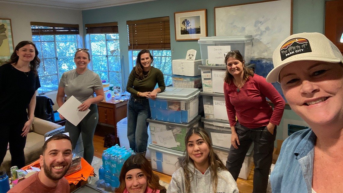 Group of people standing around diabetic supplies