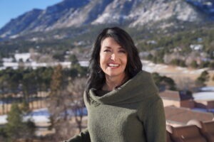 Jackie Kavcak wearing dark green sweater