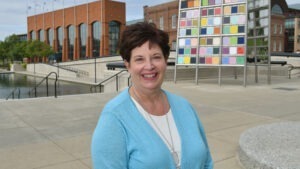 Joyce Russill wearing blue sweater and white shirt