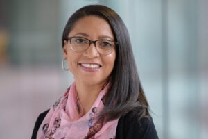 Robin Preston wearing black shirt and pink scarf