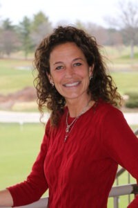 Traci Hopkins wearing red long sleeve shirt