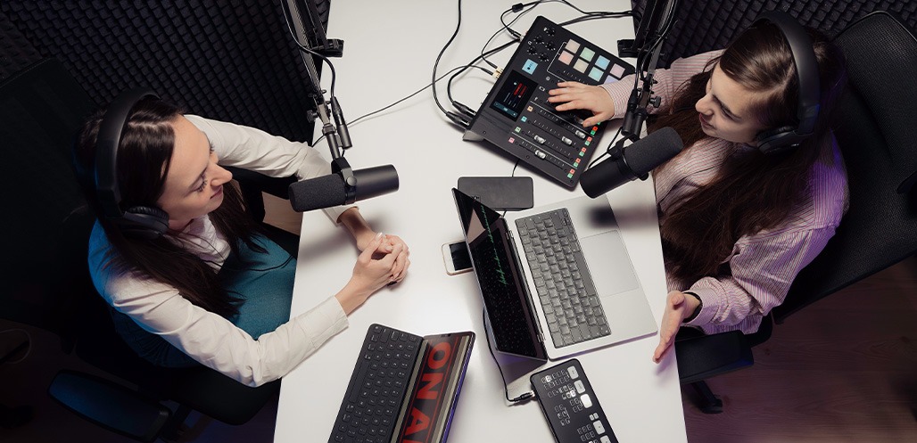 Two women talking on podcast in studio