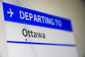 Computer screen close-up of status of flight departing to Ottawa, Canada