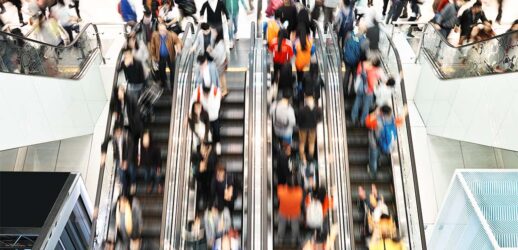 Blurry image of travelers moving up and down elevator