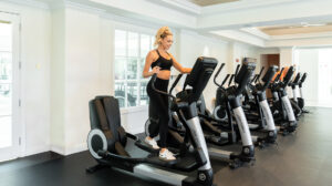 Woman using elliptical machine at gym in JW Marriott Miami Turnberry